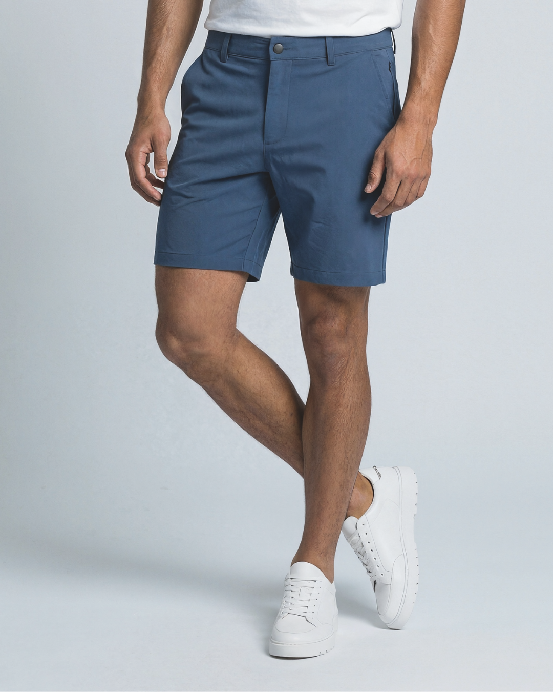 Short man wearing clothing for short men - a blue chino shorts