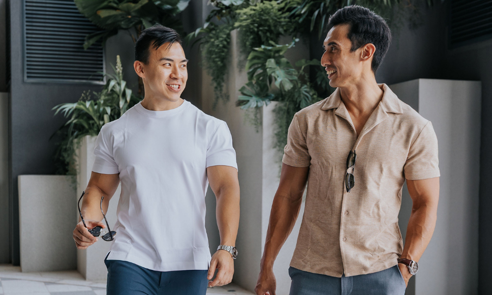 Two men standing outdoors with plants in the background - men’s tops for short men